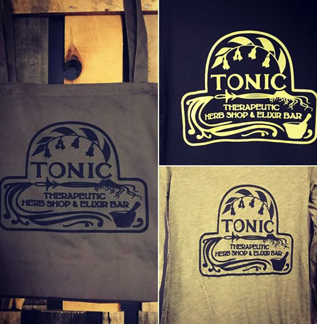 Tote bags featuring "TONIC THERAPEUTIC HERB SHOP & ELIXIR BAR" logo, showcasing custom screen printing design options for promotional apparel.
