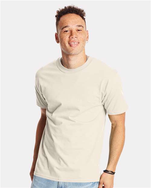 Man wearing a light-colored Hanes t-shirt, showcasing a casual style ideal for custom apparel and merchandise shopping.