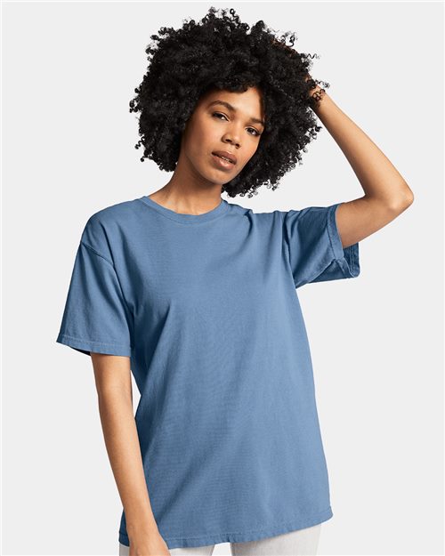 Woman wearing a blue Comfort Colors 1717 garment-dyed heavyweight t-shirt, showcasing casual style and comfort.